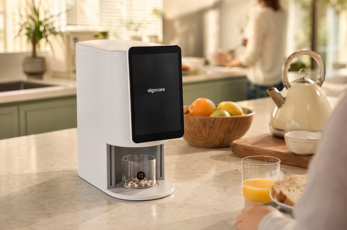 Lifestyle scene — weekend breakfast with the E1 dispenser on a family counter.