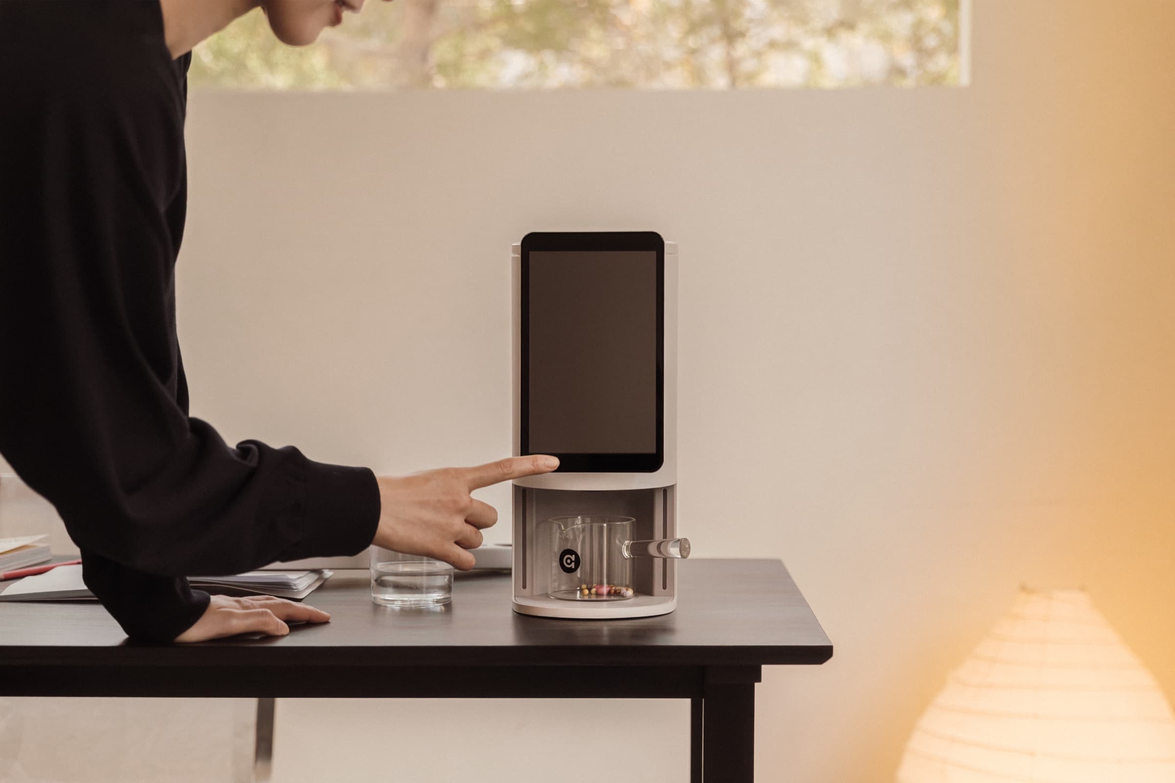 User tapping the E1 to start dispensing the daily mix.