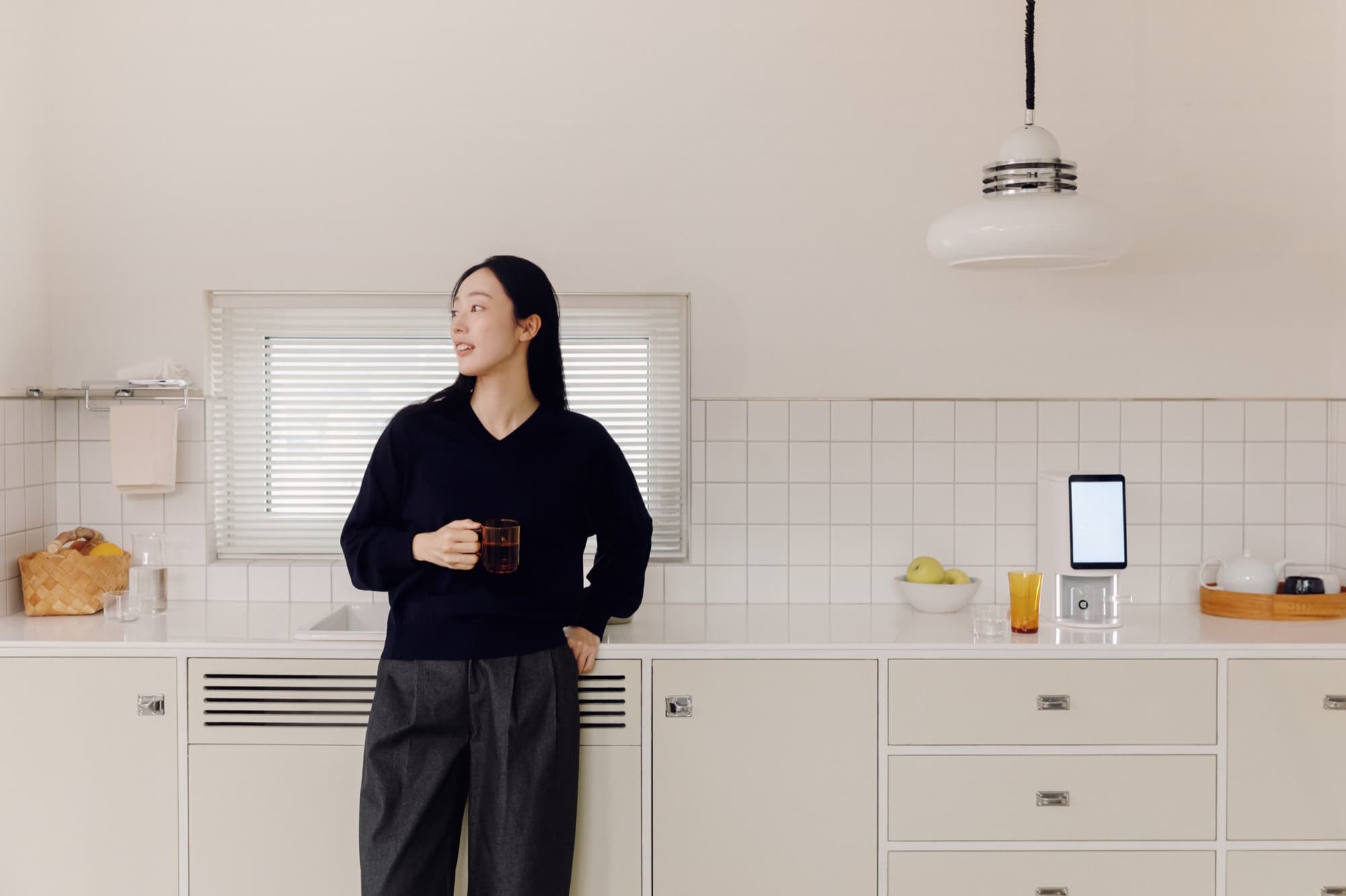 Lifestyle scene — kitchen counter morning routine with the E1 dispenser.