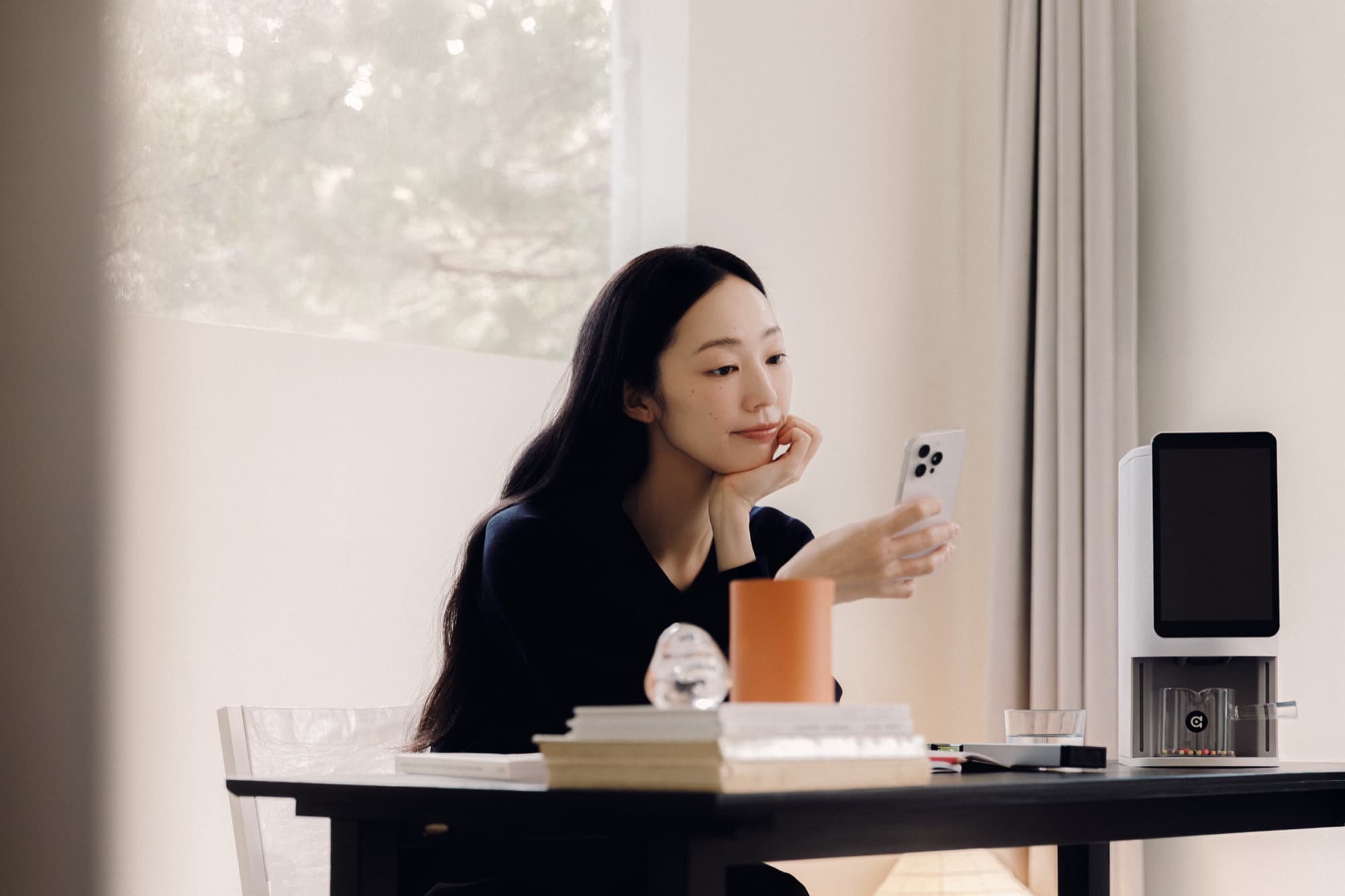 Lifestyle scene — desk-side afternoon with the E1 dispenser and a journal.
